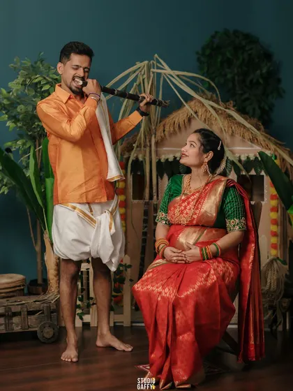A playful moment with the father-to-be serenading his wife and their unborn baby.