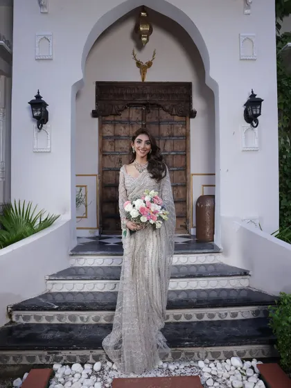 A smiling bride-to-be in her silver saree. This look is perfect for a modern engagement or reception.