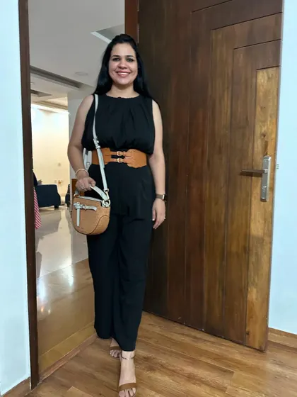 My birthday outfit from a few years ago. A classic black jumpsuit is always a great choice for a celebration. I've styled it with a statement tan belt to cinch the waist and add a pop of color.