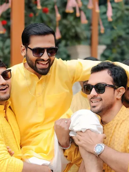 The groom's Haldi ceremony, full of laughter as his friends and brothers lift him up in celebration. It's a moment of pure fun and camaraderie.