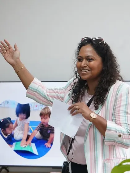 During a Parent Orientation, I am explaining how play-based education nurtures critical thinkers. Building a strong partnership with parents is a crucial part of creating a supportive learning community for every child.