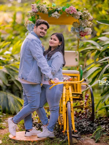 A playful pose with a yellow bicycle. The couple's matching denim outfits and their fun interaction make this a very sweet and memorable shot.