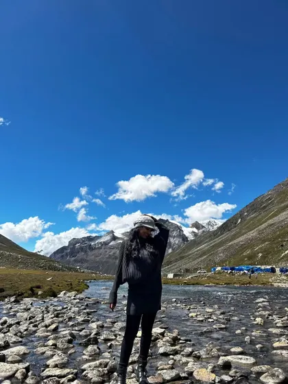 Another view from my trip to Sikkim, showing a full travel outfit against the breathtaking Himalayan landscape. This is ideal for outerwear and adventure travel brands.