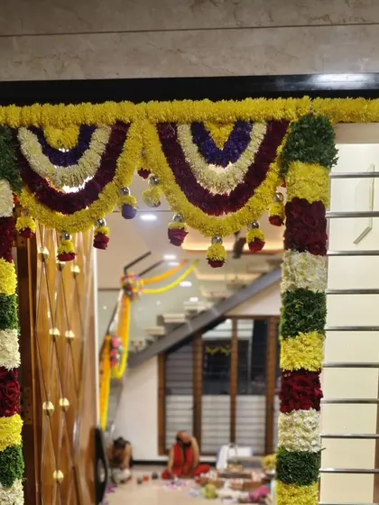 We decorated the main entrance of this home for a Gruhapravesam with thick, colorful garlands of fresh flowers, creating a warm and auspicious welcome for family and guests.