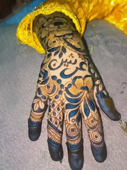 A slightly different angle of the personalized floral mehendi. The combination of delicate lines, bold floral elements, and custom calligraphy creates a stunning look for any celebration.