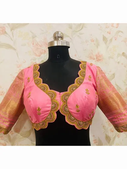 The front view of the scalloped pink blouse, showing the unique cup design and delicate embroidery.