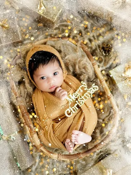 An aerial view of a newborn in our Christmas setup, complete with a "Merry Christmas" sign. These are the perfect images for holiday announcements.