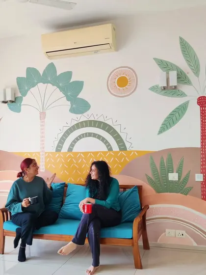 Enjoying a cup of coffee with the client on her sofa, with the beautiful new mural as our backdrop.