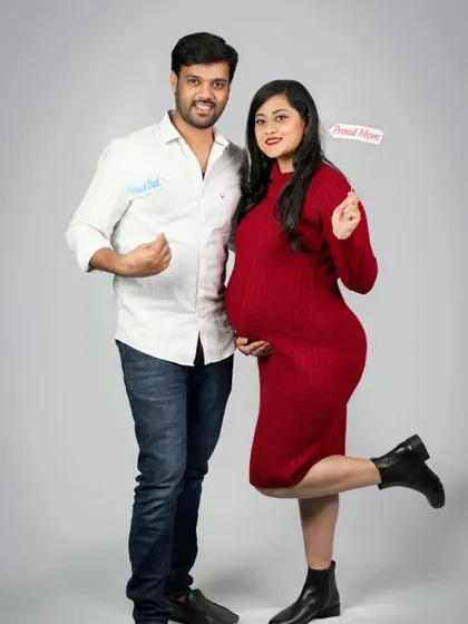 A fun and proud moment for the parents-to-be. With cute "Proud Dad" and "Proud Mom" labels, this playful shot is a perfect way to announce their excitement.