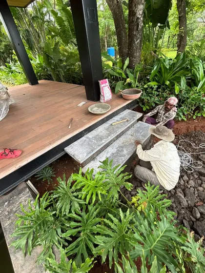 The careful placement of stone steps on-site in Alibaug. This image highlights the precision and skill of the workers as they integrate hardscape elements with the natural and built environment, ensuring every detail is perfectly executed.