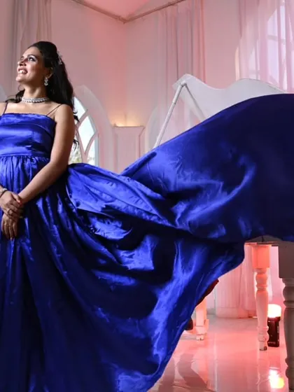 An elegant indoor shot featuring our royal blue satin gown. The fabric has a beautiful luster that looks incredible under soft lighting, perfect for a classic and sophisticated shoot.