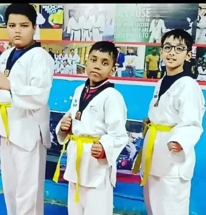 Three of my students, showing the different stages of early progression with their yellow belts.