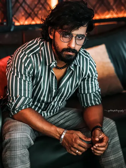 A collection of indoor portraits of an actor in a stylishly casual striped shirt. The moody lighting of the cafe setting adds a cinematic and modern feel, perfect for a character portfolio.