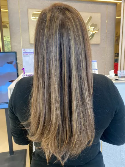 A sleek and chic hair transformation. These highlights on straight hair show off the precision of our color work.