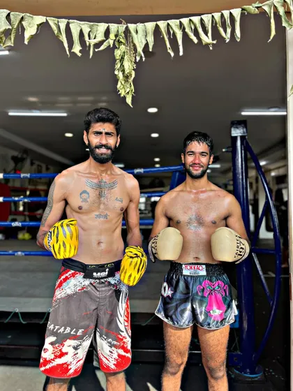 Two fighters pose after a hard sparring session. We bleed and grow together as a team. There is respect in the fight.