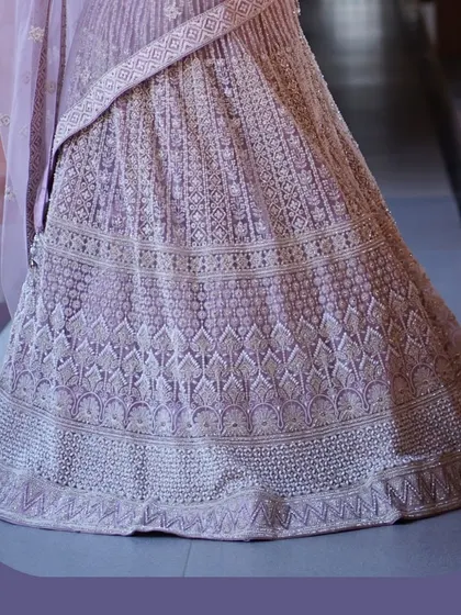 A closer look at the artistry. This pastel lehenga is covered in delicate, intricate embroidery, showcasing the hours of handwork that go into creating such a graceful and detailed piece.