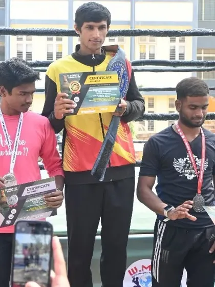 Our fighter on the podium with his championship belt at the Golden Mongkhon tournament. This is the reward for dedication to the art of eight limbs.
