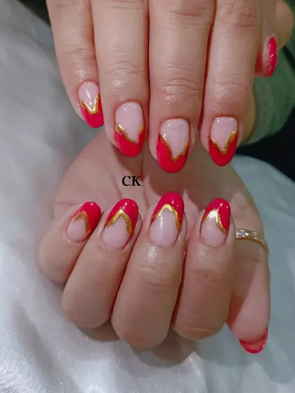 A bold and striking design featuring a red French tip with a unique V-shape, outlined in gold chrome for extra definition.