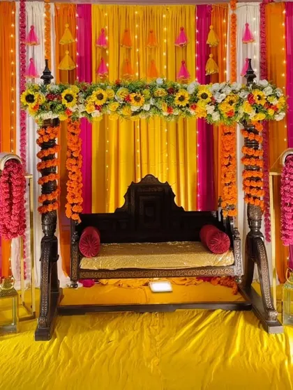 A decorated jhoola (swing) is a must-have for any Mehandi or Haldi. We adorn a traditional wooden swing with bright floral arrangements and colourful drapes to create a beautiful and fun seating area for the bride.