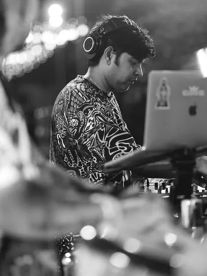 A black and white perspective of the DJ console. Here, I'm working alongside the percussion setup, showing how we integrate our sounds to create a cohesive live performance.