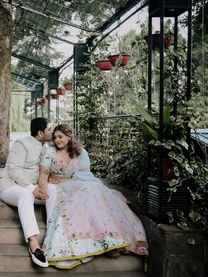 A tender moment on the steps, with the groom kissing the bride's forehead.
