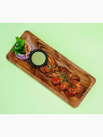 A top-down view of the tandoori wings, showing the full platter and garnish. This angle is useful for menu thumbnails and catalog listings.