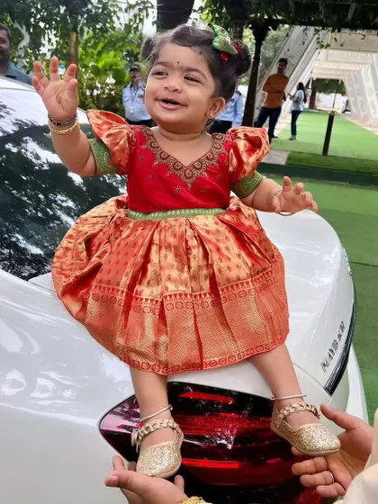 There is nothing more special than creating a tiny outfit from a mother's saree. I designed this adorable silk frock for a little princess, complete with puffed sleeves and using the rich brocade for the skirt.