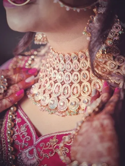 A close-up shot focusing on the bride's stunning necklace and the intricate details of her wedding jewelry.