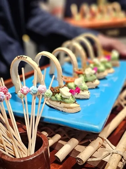 A tray of our unique edible spoons, filled with a creamy herb mousse and garnished with flowers.