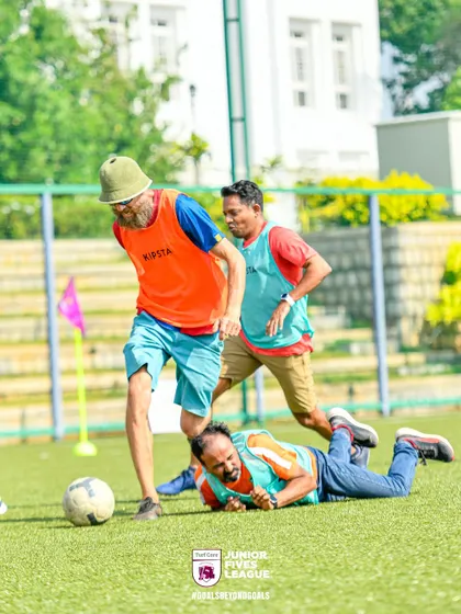 Even a stumble can't stop the play. This image captures the relentless effort and fun that participants have on the field, no matter the situation.