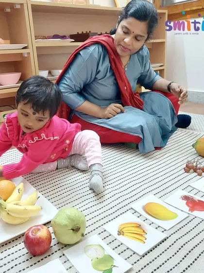 A child reaches for a pomegranate, matching it to the correct card. This hands-on lesson makes learning about healthy foods engaging and memorable.