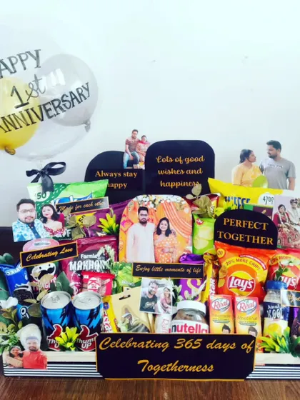 This first anniversary hamper is a perfect example of how I bring your story to life. It's packed with the couple's favorite snacks, drinks, and decorated with personal photos and custom messages to celebrate 365 days of togetherness.