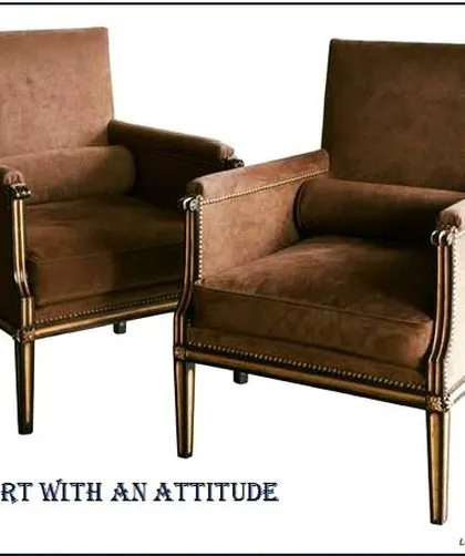 These armchairs are a perfect example of "art with an attitude." The classic frame, rich brown upholstery, and nailhead trim detailing give them a timeless and stately character, ideal for adding a touch of classic elegance.