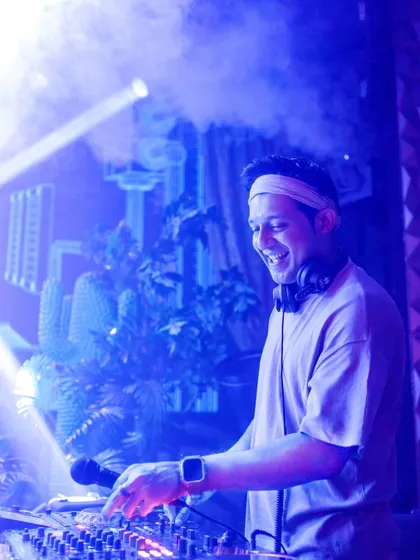 A smile on my face while mixing tracks at Happy Brew. I genuinely love what I do, and that passion translates directly to the dance floor.