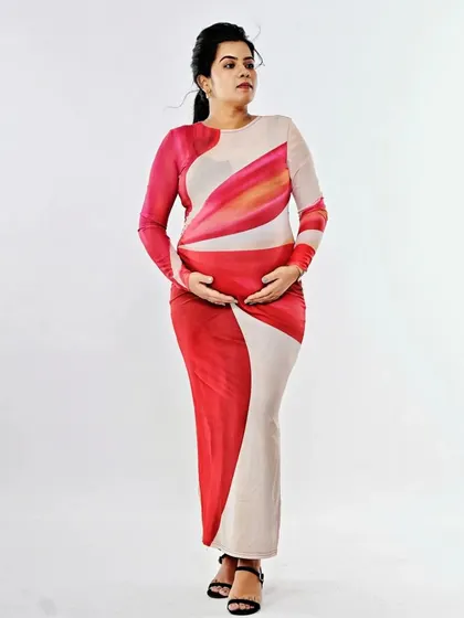 A full-length shot of the mother-to-be, looking serene and beautiful. The simple makeup and hair allow the focus to be on her and the beautiful journey she is on.