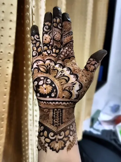 A full view of the hand with the reverse-fill floral design, showing how the pattern extends from the wrist to the fingertips.