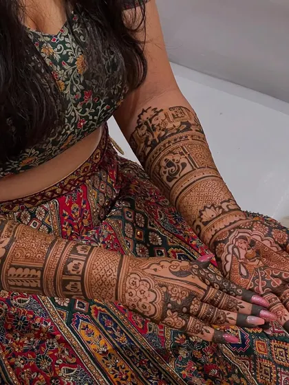 A full bridal look with intricate designs on both hands and arms, perfect for the bride who wants it all.