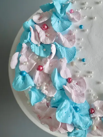 This is a close-up of the delicate, hand-piped floral work on one of my baby shower cakes. I use soft buttercream to create petal-like textures, accented with sugar pearls for a touch of elegance.