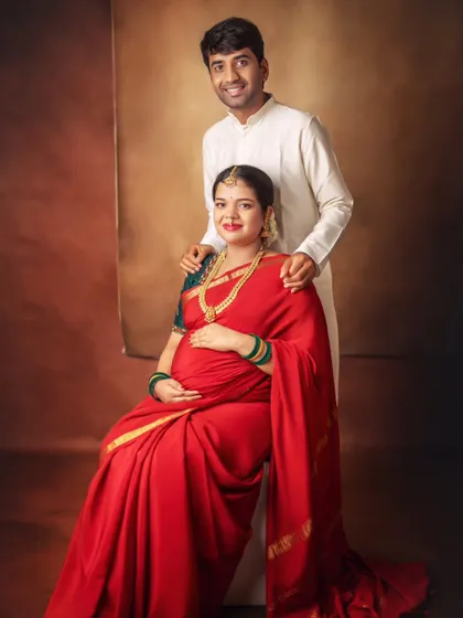 A formal portrait of the couple, radiating elegance and grace. The rich colors and classic studio lighting give this image a timeless, painted feel.