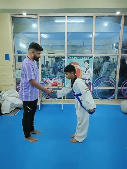 A student bows after receiving his blue belt.