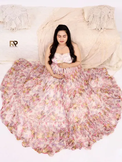 An overhead view of our client in a beautiful floral gown. This pose allows the dress to spread out like a blooming flower, creating a stunning and artistic effect.