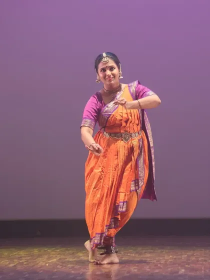 The expressive face and hands of a Bharatanatyam dancer telling a story. Our classes focus on mastering 'abhinaya', the art of expression.
