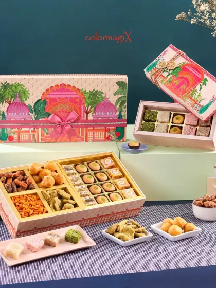 This beautifully illustrated hamper captures the essence of Indian palaces and festivities. The box is filled with a delightful assortment of mithai, savory snacks, and dates.
