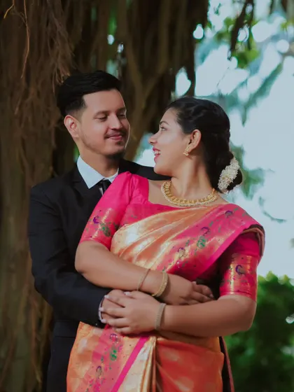 The way they look at each other speaks volumes. A classic, romantic pose that is always beautiful, especially in a lovely outdoor garden.
