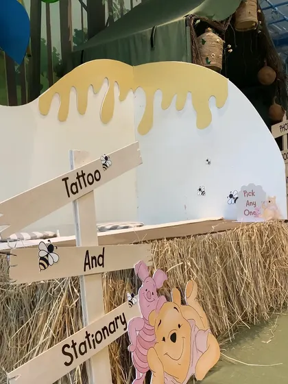 A "Tattoo and Stationery" stall at the Winnie the Pooh party, offering themed activities and take-home goodies for the guests.