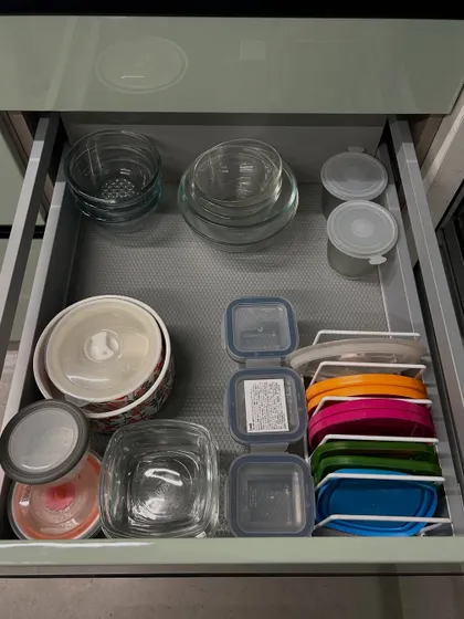 A drawer for glass bowls and storage containers. We've used a vertical file for the lids, which is our go-to trick for keeping them under control.