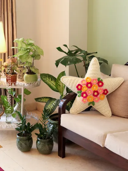 Home on a Sunday, with my star-shaped floral cushion adding a touch of handmade charm to a plant-filled corner.