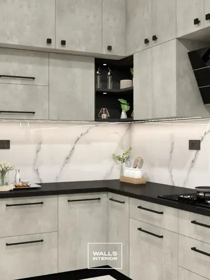 Another angle of the grey textured kitchen, showing the placement of the chimney and hob. The black handles and knobs tie the entire design together.