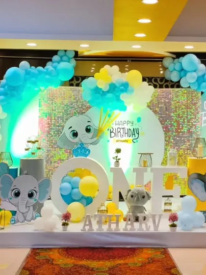 A cheerful Dumbo-themed first birthday party with a yellow and blue color palette and cute elephant props.