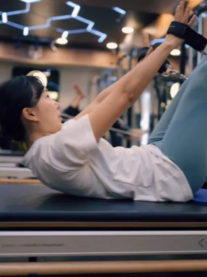This ab curl with straps on the Reformer targets the upper abdominals while maintaining a stable pelvis. It’s a controlled movement that builds strength without straining the neck.